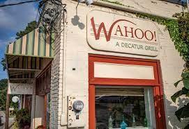 Front view of a small restaurant building with a sign that reads 'WAHOO! A Decatur Grill'.