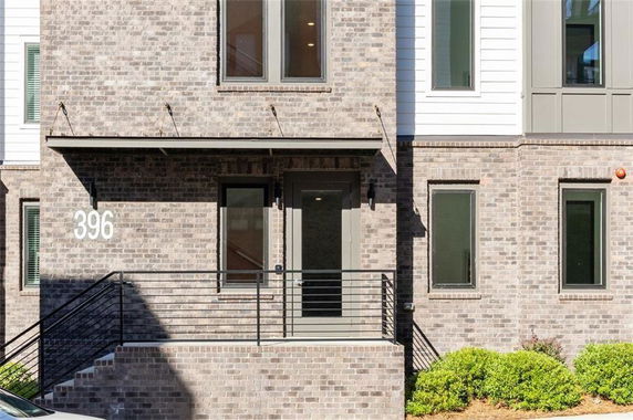 Front view of a multi-story brick building with entrance and windows.