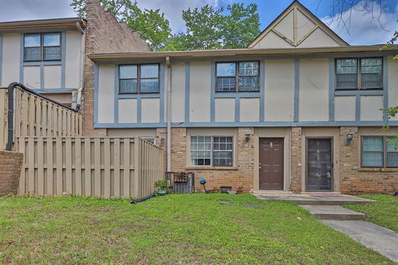 Front view of a two-story townhouse with brick and panel exterior.