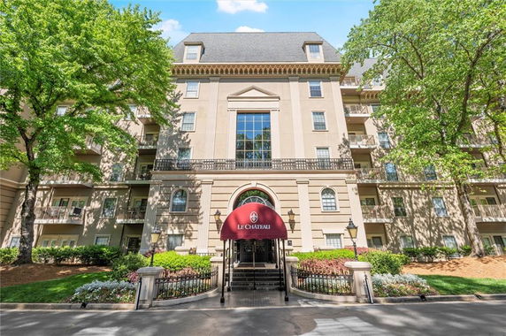 Front view of a multi-story building with a decorative entrance canopy.
