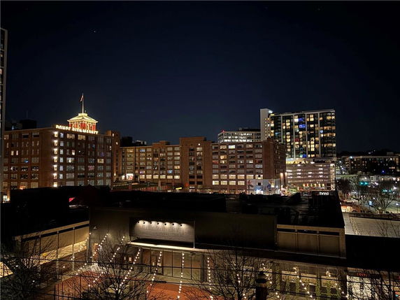 Night view of a cityscape with illuminated buildings.