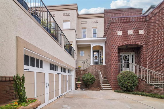 Front view of a house with two garages and a brick facade.