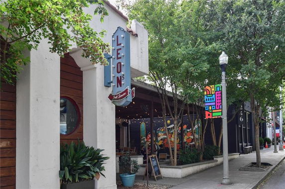 Front view of a commercial building with restaurant signage.