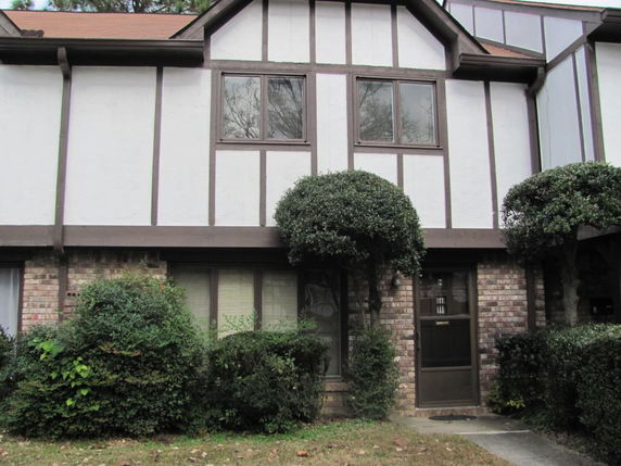 Front view of a two-story house with Tudor-style architecture.