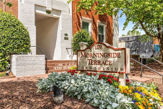 Front view of a condominium building with brick and white walls, featuring a sign for Morningside Terrace.