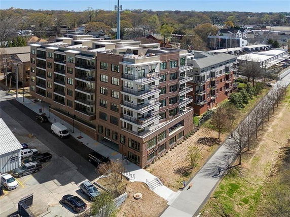 Front view of a multi-story residential building with balconies.