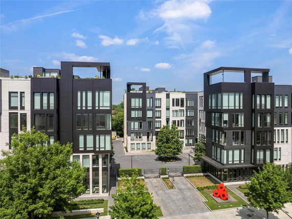 Front view of modern multi-story buildings with large windows and dark accents.