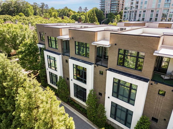 Front view of a multi-story building with large windows and balconies.