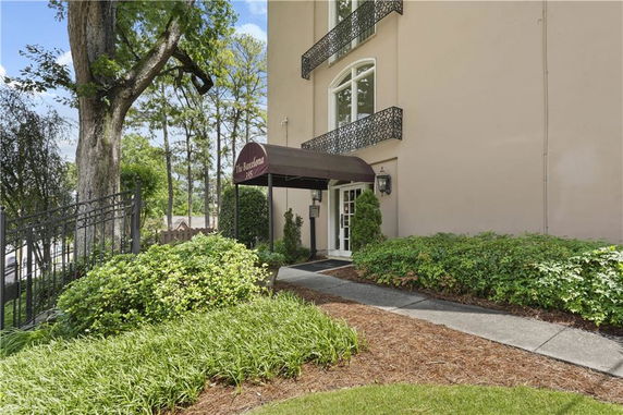 Front view of a multi-story building with a brown awning entrance.