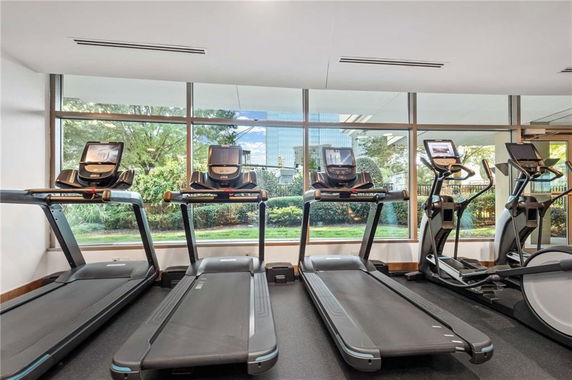 Indoor gym area with treadmills and elliptical machines.