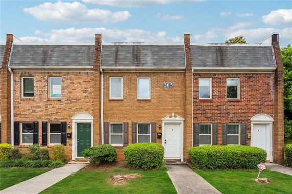Front view of a brick townhouse with multiple units.