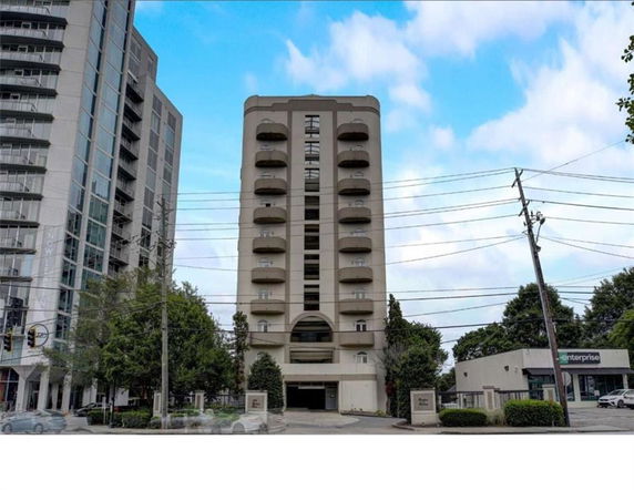 Front view of a mid-rise apartment building with multiple balconies.