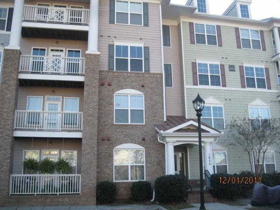 Front view of a multi-story residential building with balconies.