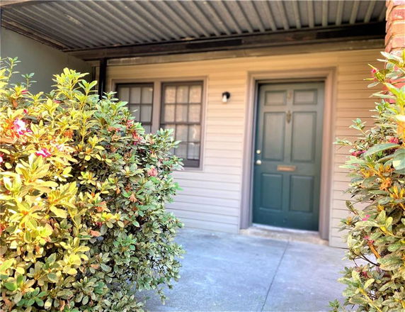 Front view of a house entrance with a covered entrance area.