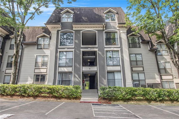 Front view of a multi-story apartment building with columns.