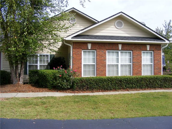 Front view of a single-story house with brick and siding exterior.