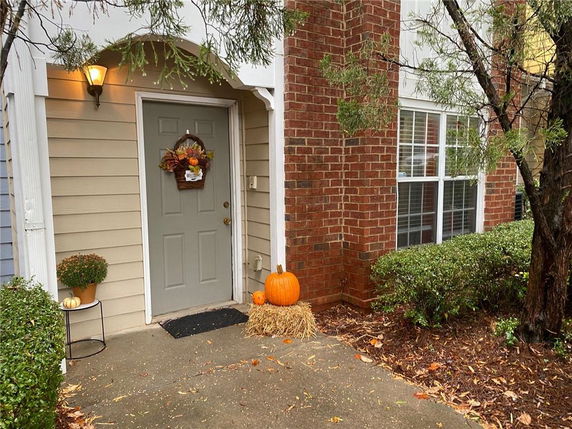 Front view of a house with a brick exterior and decorated entrance.