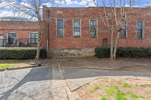 Front view of a brick building with multiple windows.