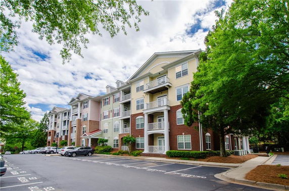Front view of a multi-story residential building with balconies.