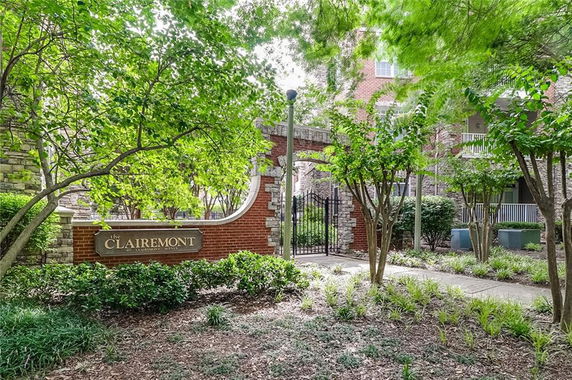 Front elevation of a building entrance with a brick and stone gate featuring signage for 'The Clairemont'.