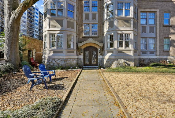 Front view of a multi-story brick building with a decorative entrance.