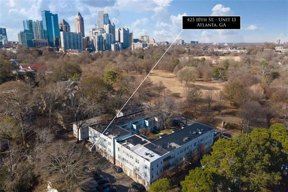 Aerial view of a residential area with city skyline in the background.