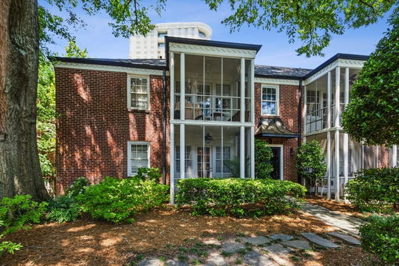 Front view of a two-story brick house with columned porches.
