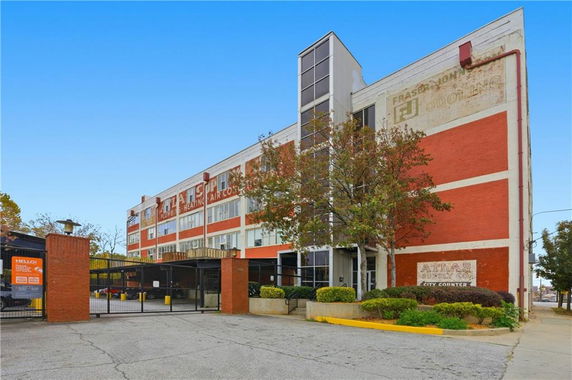 Front view of a multi-story brick building with industrial architecture.