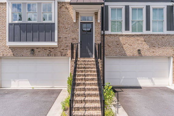 Front view of a house with brick exterior and two-car garages.