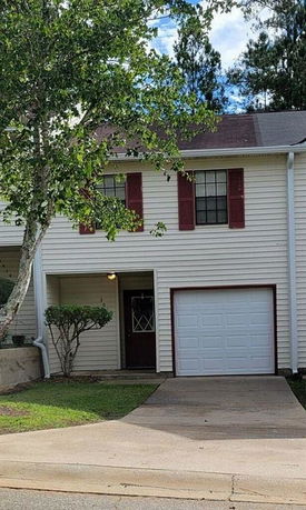 Front view of a two-story house with a garage.
