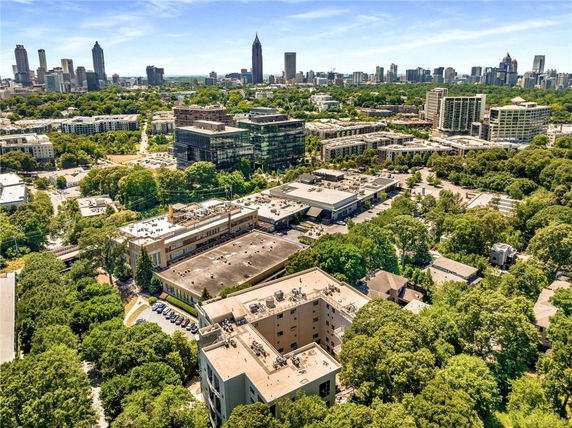 Panoramic view of a cityscape with multiple buildings and greenery.