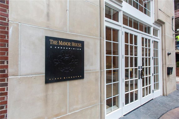 Front view of a condominium entrance with a glass door.