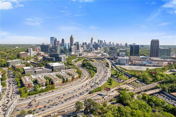 Panoramic view of a cityscape with highways and skyscrapers.