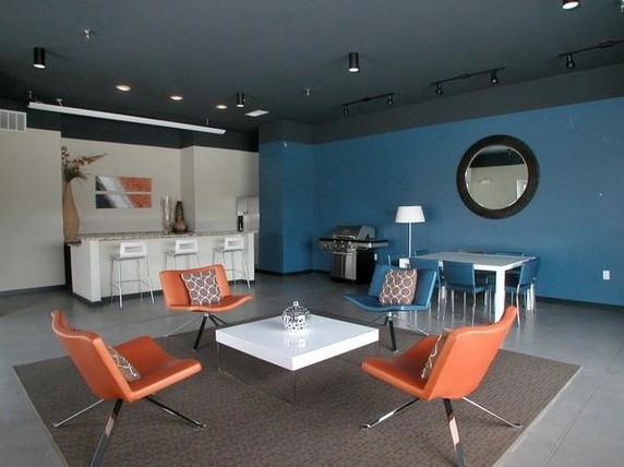Recreational area with modern furniture and kitchen facilities.