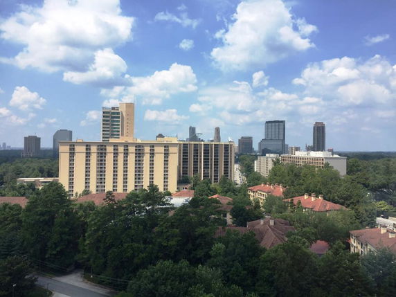 Panoramic view of multiple buildings in a city landscape.