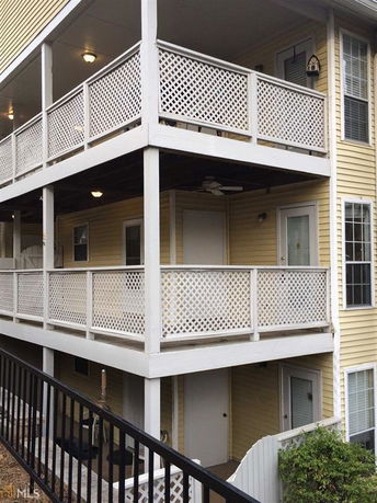 Front view of a multi-story building with lattice work on balconies.
