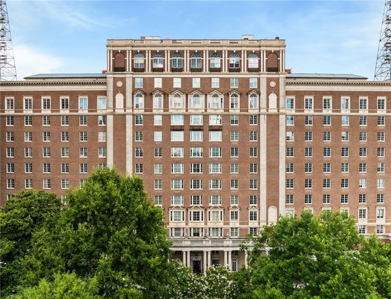 Front view of a multi-story brick building with numerous windows and architectural details.