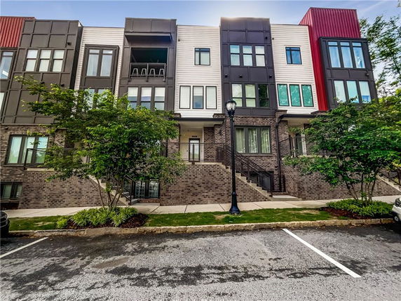 Front view of a multi-story residential building with modern design elements.