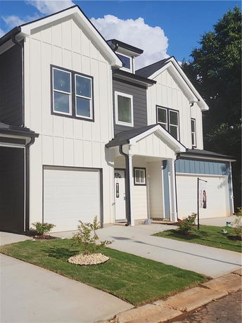 Front view of a modern two-story house with a garage.