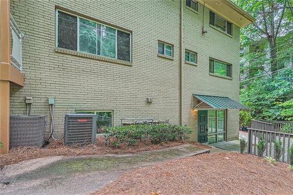 Side view of a multi-story brick building with several windows.