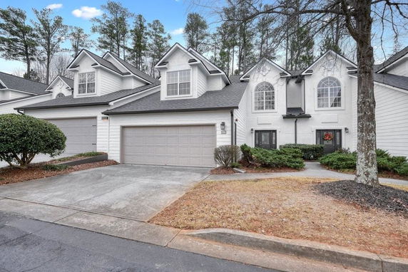 Front view of a two-story house with multiple gables and a double garage.