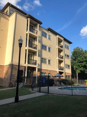 Front view of a multi-story apartment building with balconies.