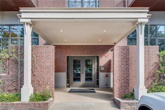 Entrance view of a brick building with a covered porch.