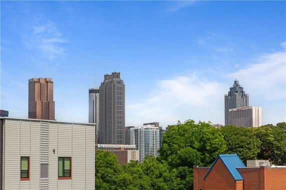Panoramic view of city skyscrapers in the background with a mix of modern and older buildings.