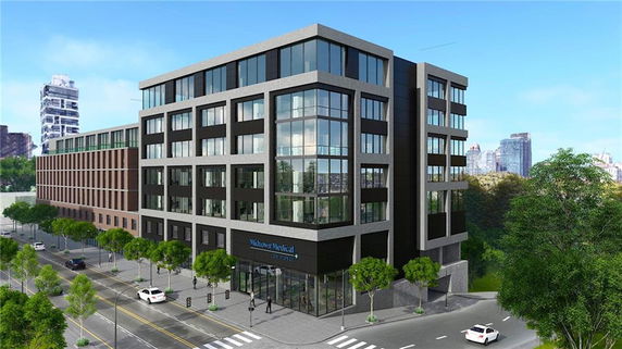 Front view of a multi-story commercial building with large windows and a sign for Midtown Medical.
