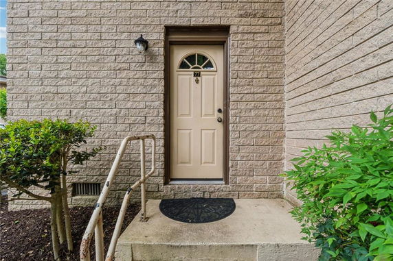 Front view of a house entrance with a single door and a small step.