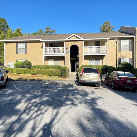 Front view of a two-story apartment building with balconies.