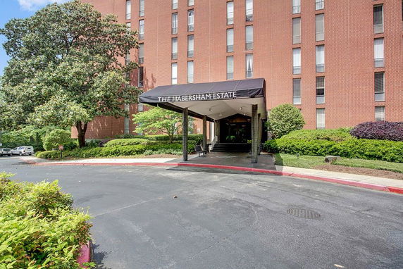 Front view of a multi-story brick building with a covered entrance.