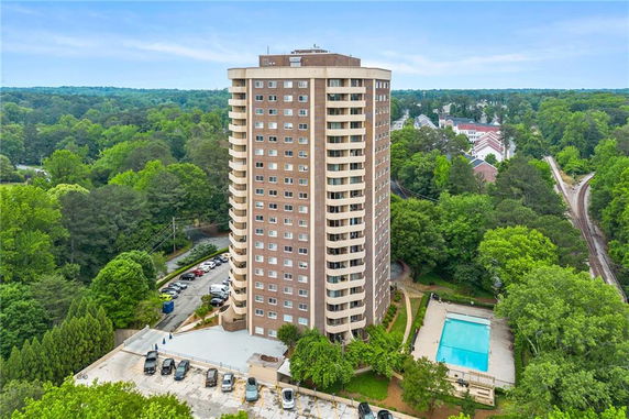 Front view of a tall apartment building with balconies.