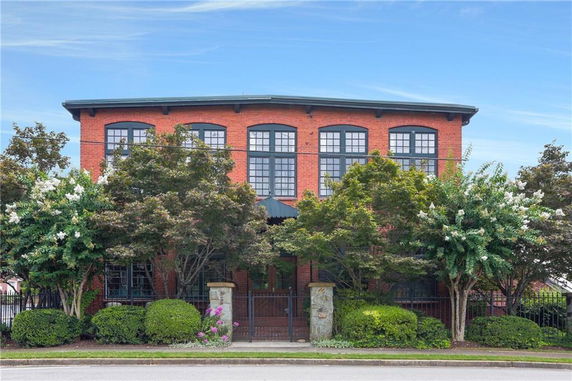 Front view of a two-story brick building with large windows